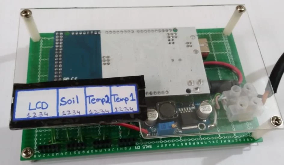 Physical Arduino controller assembly with a labeled display mockup, wiring and terminal connections.